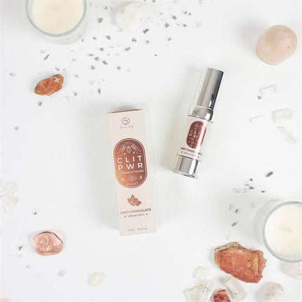 Clit Pwr Mint Chocolate stimulating balm 15 ml package with product bottle on white background.