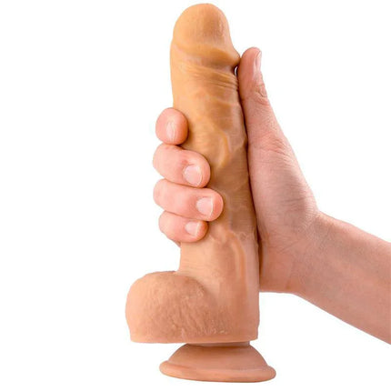 Hand holding Cloud Realistic Dildo with Testicles 8.3 Flesh showing detailed texture and suction base.
