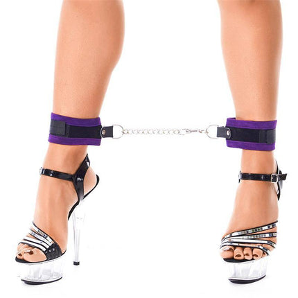 Close-up of legs with Complete Restraint Set Purple cuffs and high heels.