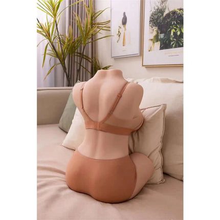 Dania Torso with Thrusting 19.5 cm realistic masturbator in soft TPR, featuring adjustable thrusting modes, positioned on a couch.