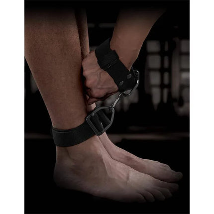Person wearing Deluxe Cuff Set securing ankles with heavy-duty nylon straps