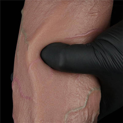 Close-up of Dildo Dual Layered Silicone XXL 9.5 texture with a hand squeezing the double density surface