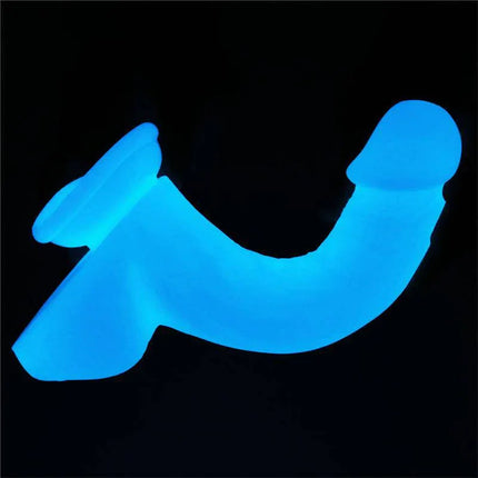 Dildo Lumino Play 8.0 glowing in the dark, featuring a curved design for versatile pleasure, made from body-safe materials.