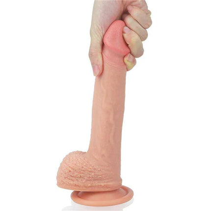 Hand holding Dildo Nature 8.5 Liquid Silicone Flesh with suction base, showcasing lifelike texture and flexibility.