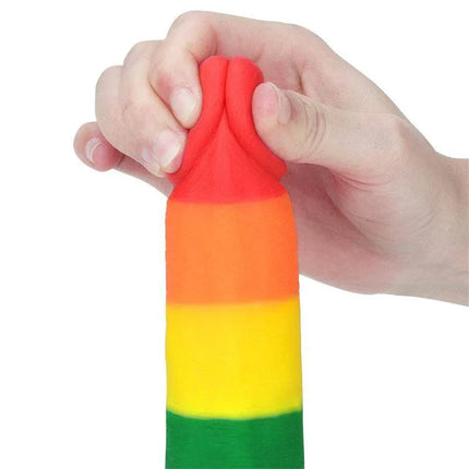 Hand holding Dildo Prider 7.5 Liquid Silicone LGBT in rainbow colors