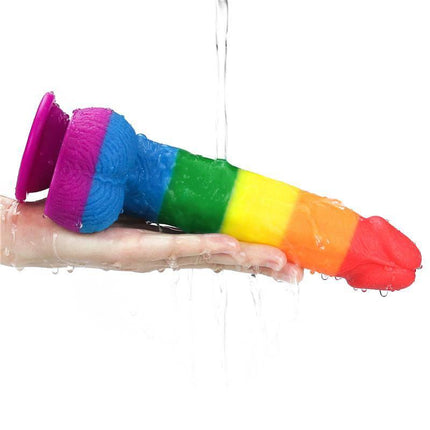 Hand holding Dildo Prider 9 Liquid Silicone LGBT in rainbow colors, showcasing medical-grade silicone quality and vibrant design.