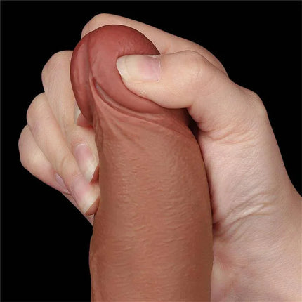 Close-up of Dildo Sliding Skin 8.5 Brown, showcasing lifelike texture and dual-density flexibility held in a hand.