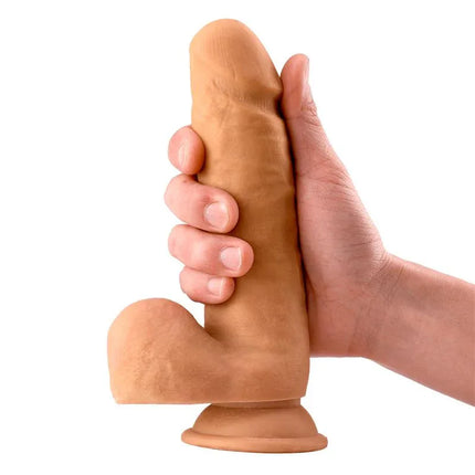 Dimi Realistic Dildo with Testicles 7.9 Flesh held in hand, showcasing lifelike design with veins and rounded glans for authentic sensation.