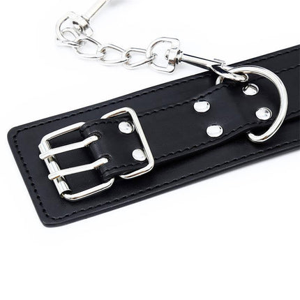 Close-up of Double Buckle Adjustable handcuffs with secure two-point buckle design and chain attachment for BDSM play.