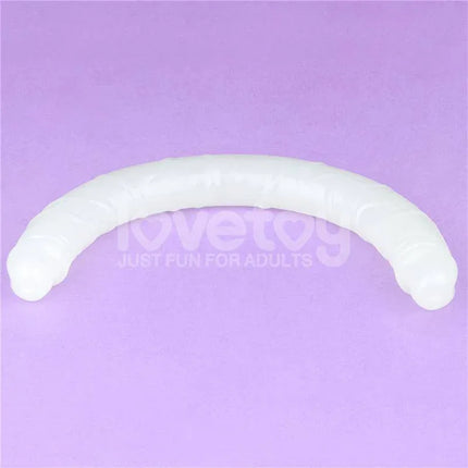 Double dildo Lumino Blue Light 18.5 glow-in-the-dark dual-ended pleasure toy on purple background