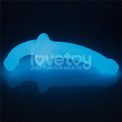 Double dildo Lumino Play Blue Light 10.5 glowing in the dark, showcasing its dual-ended design for enhanced intimate experiences.