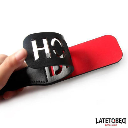 Close-up of Double Layers Paddle BITCH 32 cm, featuring PU construction with a bold design, part of the Latetobed BDSM Line.