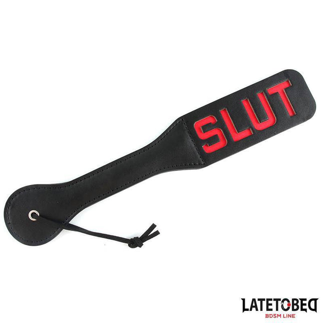 Double Layers Paddle SLUT 32 cm BDSM accessory by Latetobed with bold red lettering on black PU. Ideal for couples seeking intense sensations.