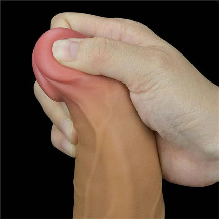 Hand holding Dual Layered Vibe with Rotation 9, highlighting lifelike silicone texture and design.