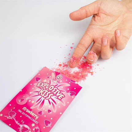 Explosive Candies Oral Sex Popping Candies 1 Sachet Strawberry Flavor spilling from package with hand over pink candy.