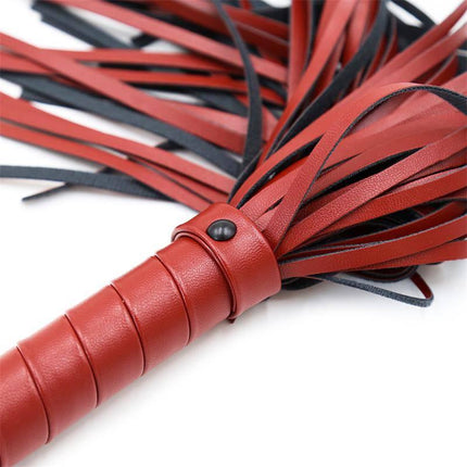 Detailed view of Extra Soft Flogger 40 cm with luxurious red and black strands and an elongated handle designed for intimate play.