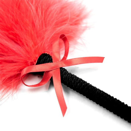 Feather Tickler with Bow 25 cm Red featuring a textured black handle and vibrant red feathers for enhanced intimate experiences.