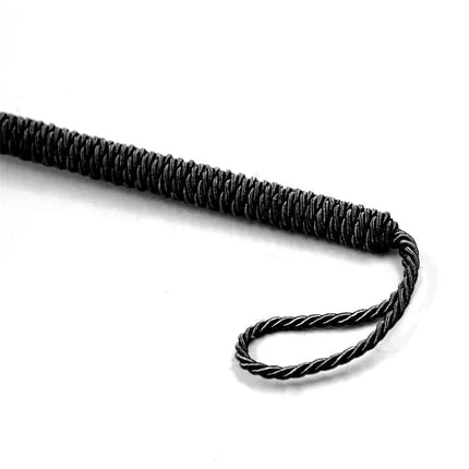 Close-up of black handle, resembling textured grip, ideal for intimate tools like Feather Tickler with Bow 25 cm Red.