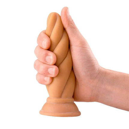 Person holding Felix Adaptable Butt Plug 5.9 Flesh by Max & Co, showing flexible twisted design and comfortable grip.