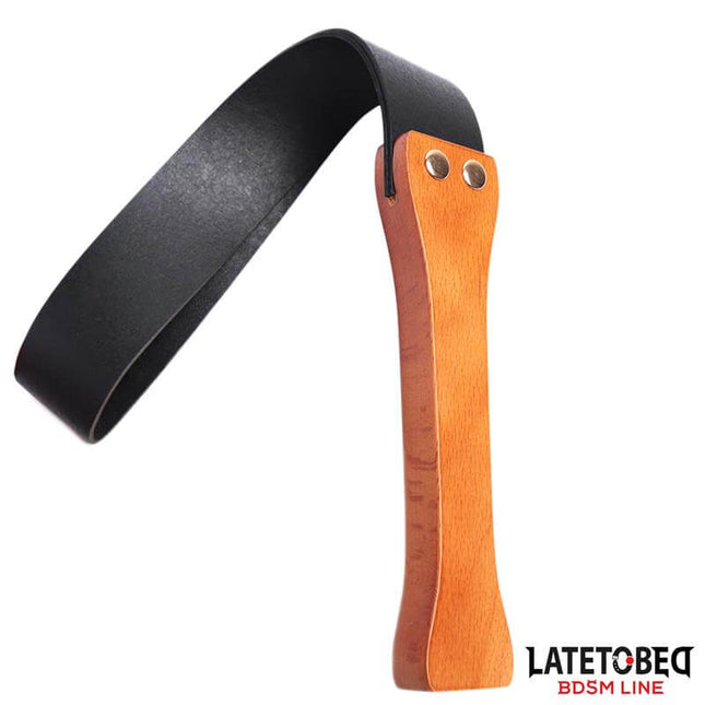 flexible wooden spanking paddle with double-layer black strap and ergonomic wood handle from Latetobed BDSM Line