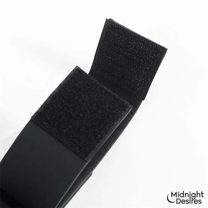 Close-up of Flexible Bondage Bar with vegan leather cuffs by Midnight Desires.