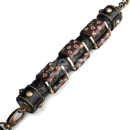 Close-up of black and brown PU leather handle of Flogger Rebellion Reign 23.5 with metal accents.