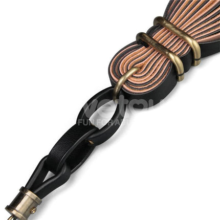 Close-up of Flogger Rebellion Reign 23.5 with black and brown PU leather handle and synthetic leather tails.