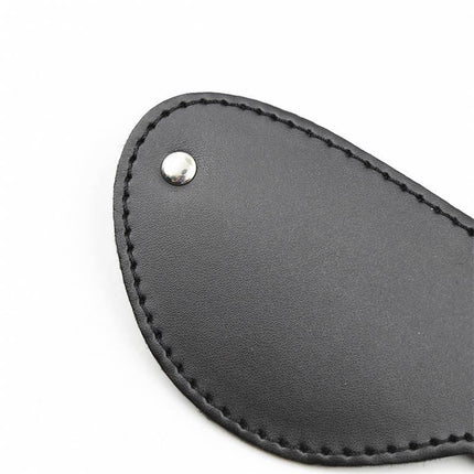 Close-up of black leather panel with rivet, part of Fur Blindfold with 3 Rivets for sensory play