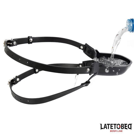 Gag with Drinker being filled with water, featuring adjustable black straps.