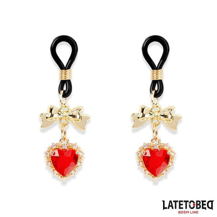Gem Pendant nipple clamps with gold-tone bows and jeweled hearts, part of the Latetobed BDSM line, featuring silicone and rhinestones.