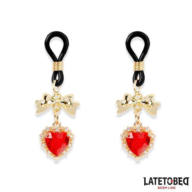 Gem Pendant nipple clamps with gold-tone bows and jeweled hearts, part of the Latetobed BDSM line, featuring silicone and rhinestones.