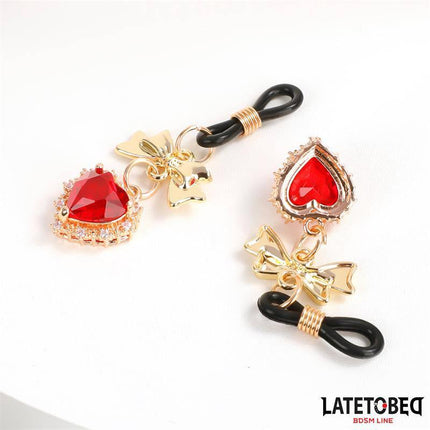 Gem Pendant nipple clamps with red jeweled hearts and gold-tone accents from Latetobed BDSM Line.
