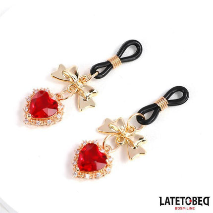 Gem Pendant nipple clamps with red rhinestone hearts and gold-tone bows from Latetobed BDSM Line.