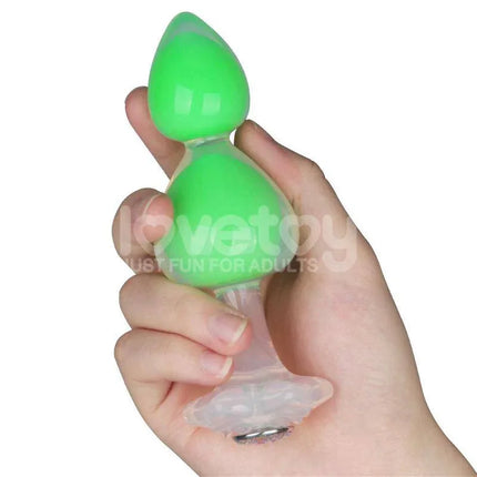 Hand holding Gemoria Silicone Butt Plug with Glow in Dark Feature, showcasing ergonomic shape and vibrant green glow.