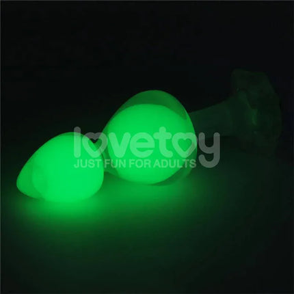 Gemoria Silicone Butt Plug with Glow in Dark Feature illuminated in a dark setting showcasing its bright green glow.