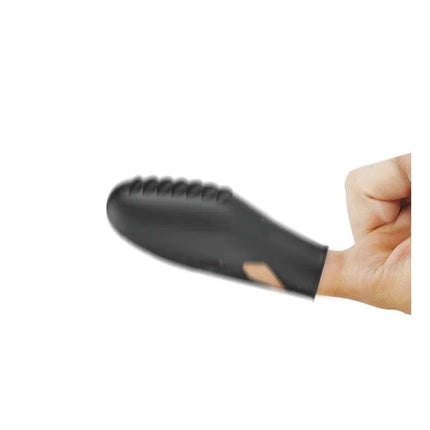 Gilo Finger Vibrator in black silicone sleeve with elastic strap for intimate exploration on hand.