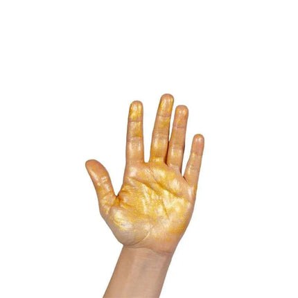 Hand covered in golden Glow Body Oil showing luminous effect from Pretty But Wild collection.