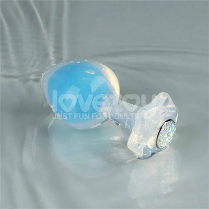 Glow in the Dark Butt Plug - Gemoria Steel Ball Design with blue illumination on reflective surface