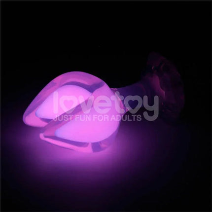 Glow in the Dark Silicone Butt Plug by Gemoria glowing pink in the dark for enhanced visual appeal and ergonomic exploration.