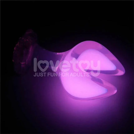 Glow in the Dark Silicone Butt Plug by Gemoria glowing in low light, featuring ergonomic design with double crescent tips for comfort.