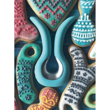 Gvibe Mini Stimulator Tiffany Mint with ergonomic silicone wings and intuitive controls, surrounded by colorful cookies.