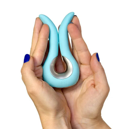 Gvibe Mini Stimulator Tiffany Mint in hands showcasing ergonomic silicone design with two flexible wings.