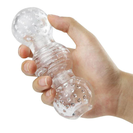 Hand holding Hannx3 Ultimate Handjob Stroker 5.7 with clear, textured design made from premium silicone and TPR materials.