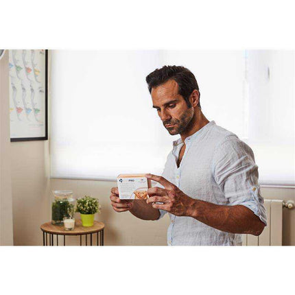 Man examining Hemapro Hemorrhoids Pills 60 Tablets in a well-lit room