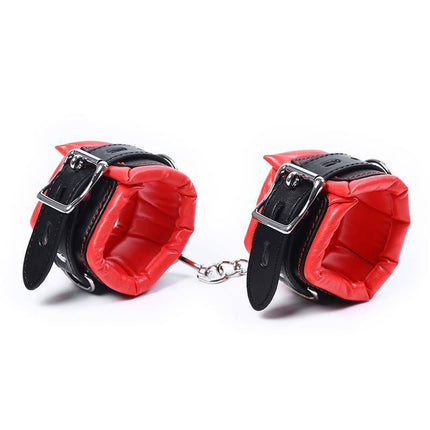 High performance ankle cuffs with adjustable buckles and red padded lining for comfort and durability in BDSM play.