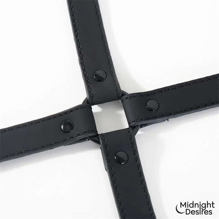 Close-up of Hogtie Cross Bar Hand and Ankle Cuffs by Midnight Desires showcasing the cross-shaped spreader in vegan leather.
