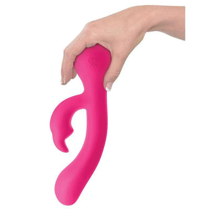 Hand holding JIMMYJANE Rabbits Ruby Rabbit vibrator with curved design and sealed ears for maximum comfort