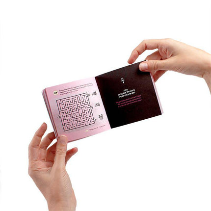 Person holding instruction book from Juego The Secret Pyramid game, featuring maze and text, designed for adventurous gameplay.