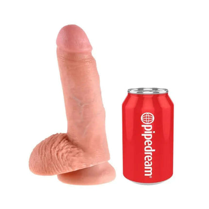 King Cock Cock with Balls 7 - Flesh dildo next to a red Pipedream can for size comparison