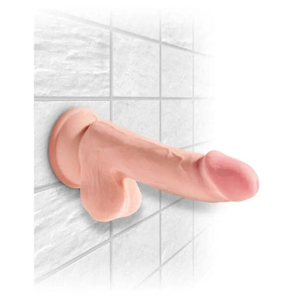 Triple Density Dildo with Testicles 6.5 on tile surface with secure suction cup.